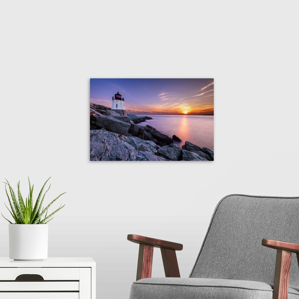 A modern room featuring Long exposure photograph of a lighthouse on a rocky cliff with a beautiful sunset over the water.