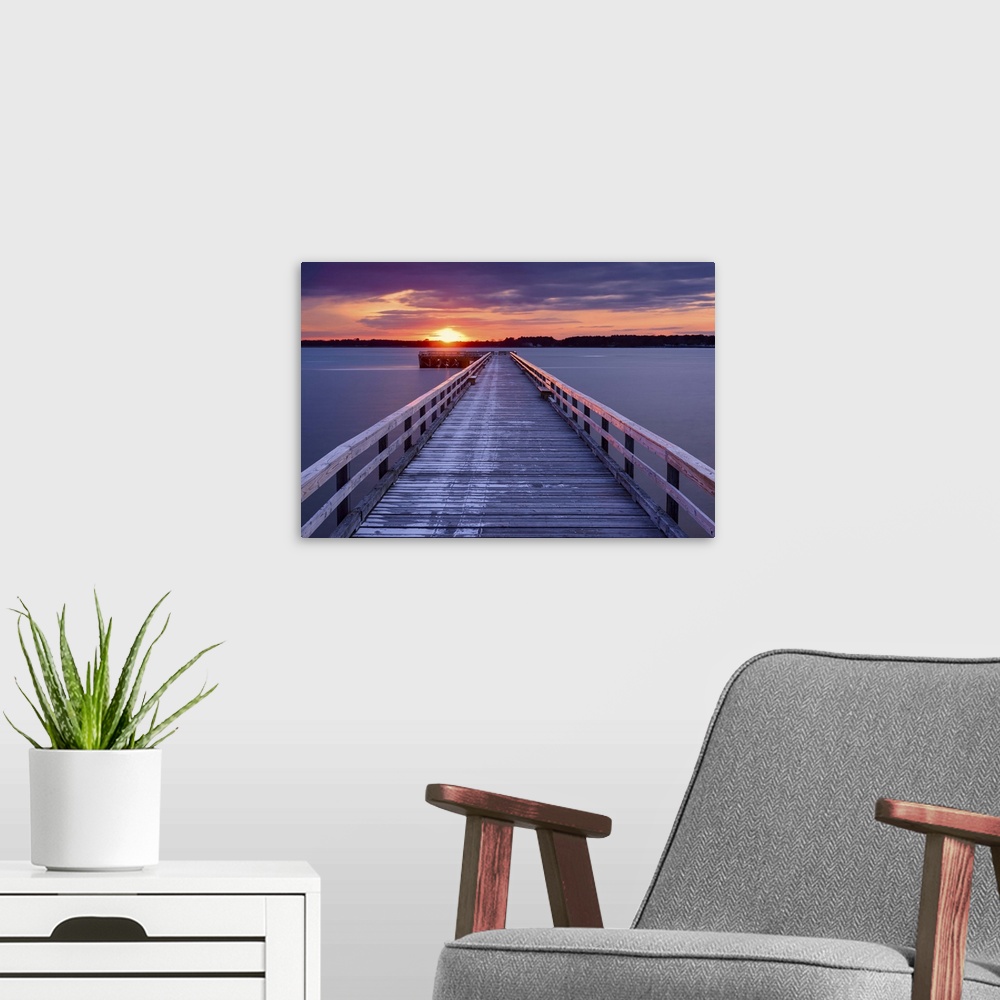 A modern room featuring Photograph of a long, wooden pier at Fort Foster, Maine, with a pink and purple sunrise.