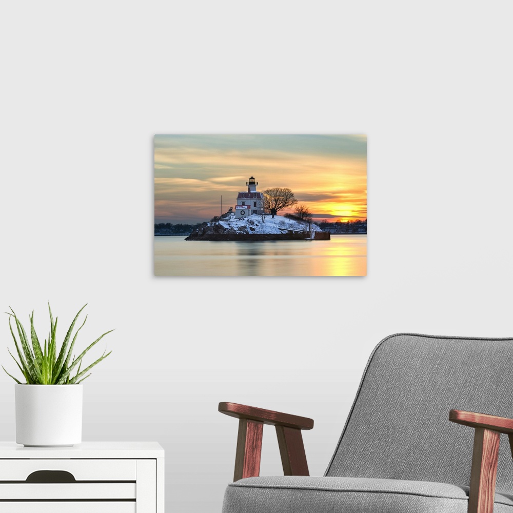 A modern room featuring A photograph of a lighthouse under a sunset sky.