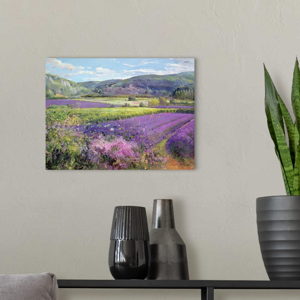 A modern room featuring Big painting of fields of lavender with rolling hills in the background. Cooling tones are featur...