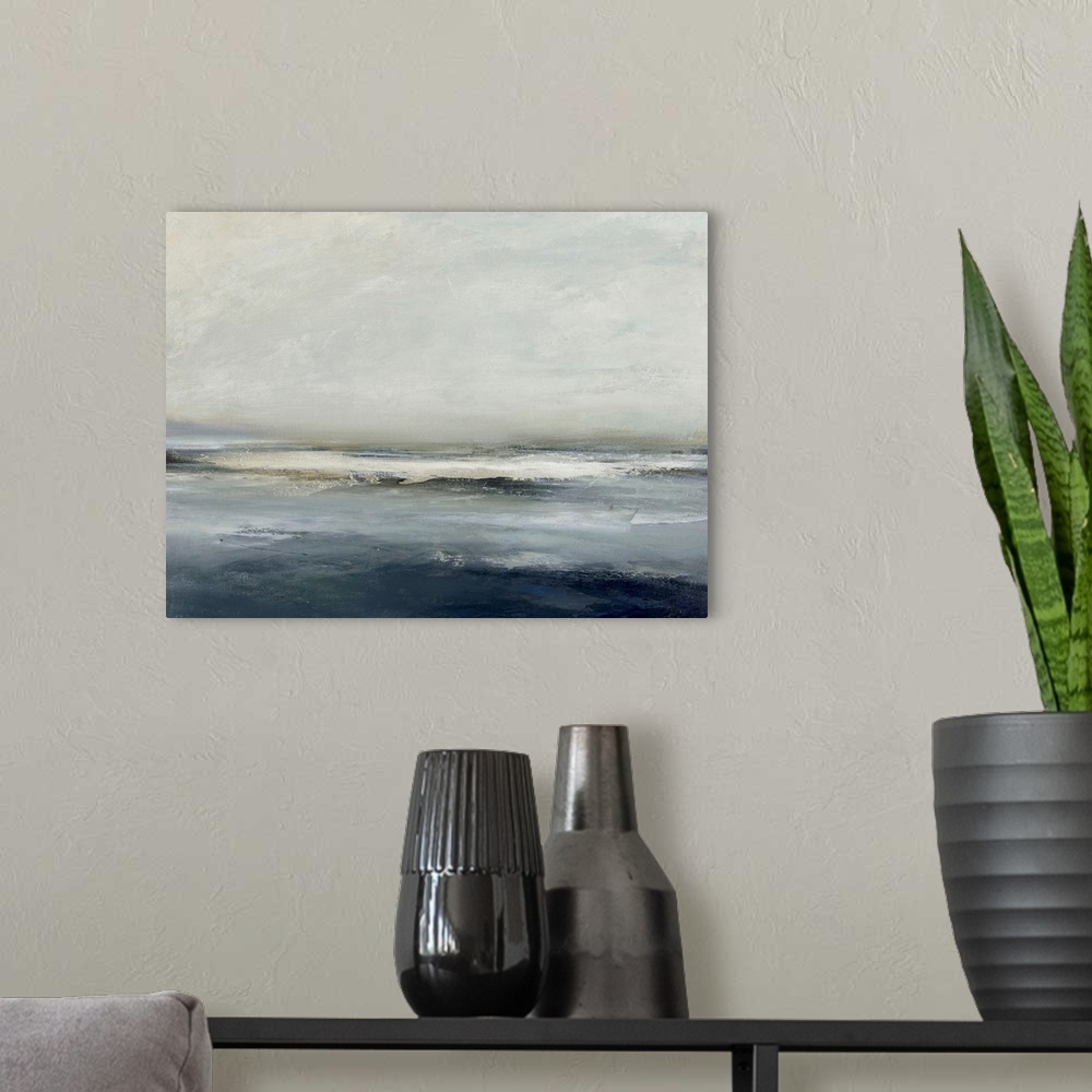 A modern room featuring Contemporary abstract artwork of blue and gray colors that resemble landscape with a horizon line.