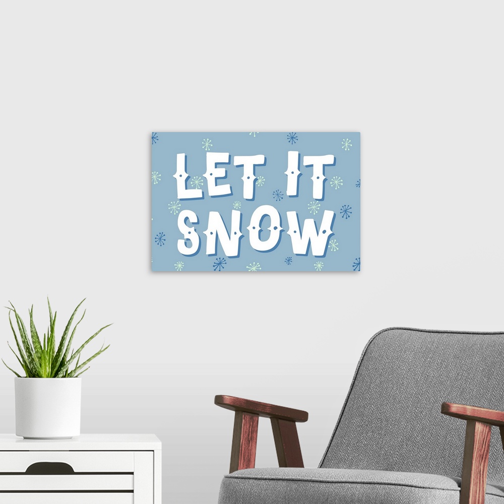 A modern room featuring Graphic holiday art with large text surrounded by snowflake graphics on a cool background.