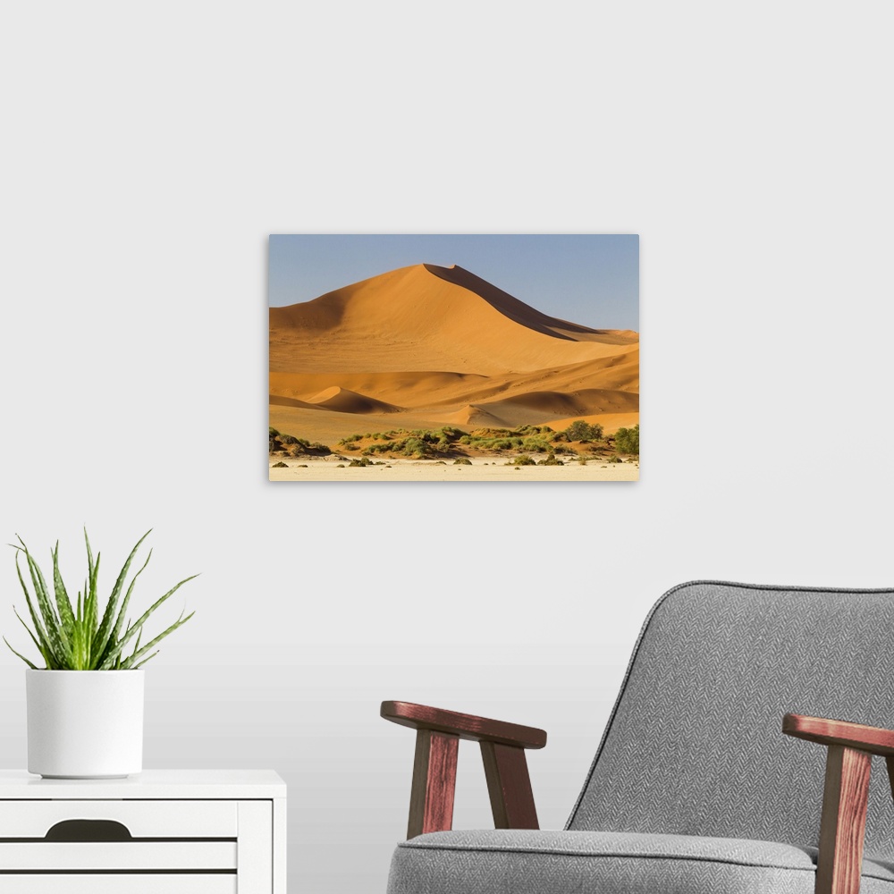 A modern room featuring Africa, Namibia, Namib Desert, Namib-Naukluft National Park, Sossusvlei.  Large red dune rising f...