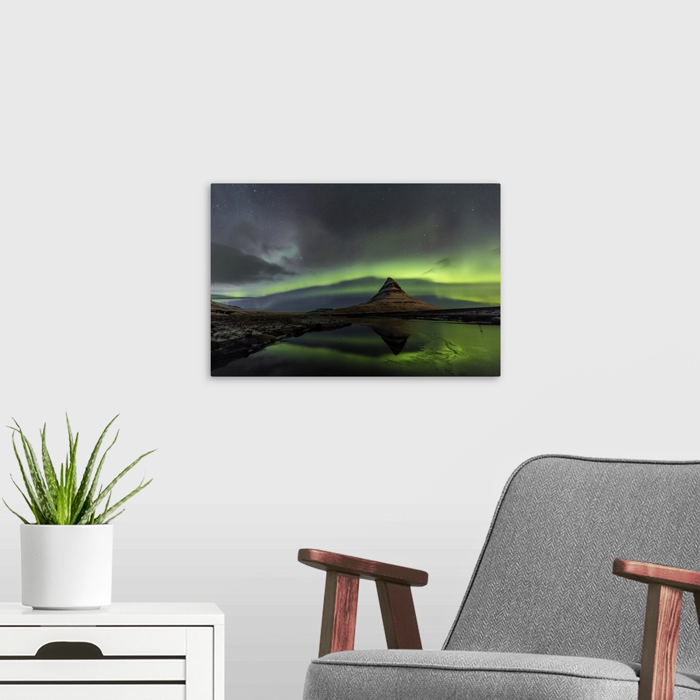 A modern room featuring Aurora borealis reflects below Kirkjufell aka Church Mountain on the Snaefellsnes Peninsula in we...