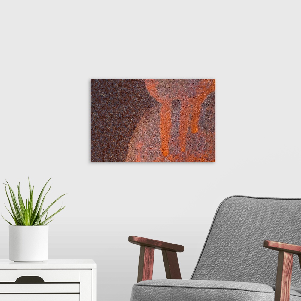 A modern room featuring Details of rust and paint on metal.