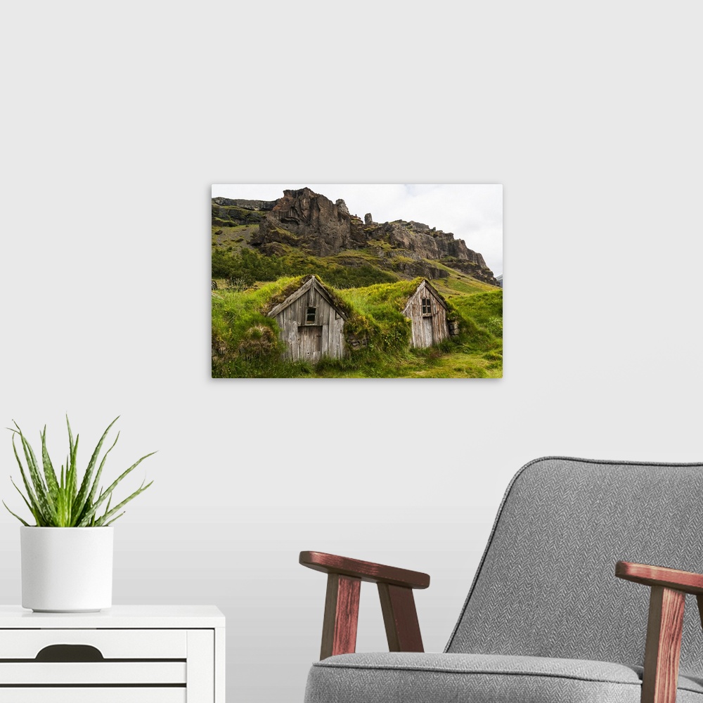 A modern room featuring Europe, Iceland, Southeast Iceland, Nupsstadur Turf Farmsted. Old homes covered with turf for pro...