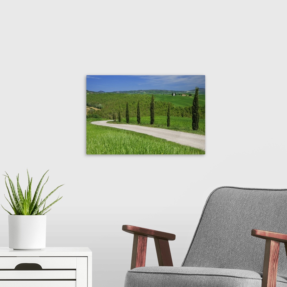 A modern room featuring Europe, Italy, Tuscany. Dirt road with Vitaleta Chapel in distance.