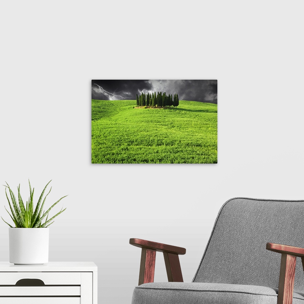 A modern room featuring Europe, Italy, Tuscany. Lightning behind cypress trees on hill.