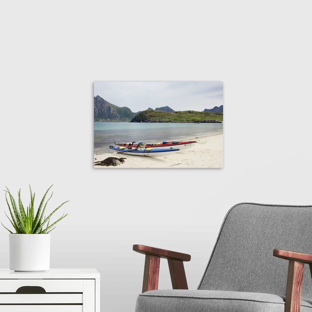 A modern room featuring Europe, Norway, Vesteralen. Sea kayaks on beach at Hovden.