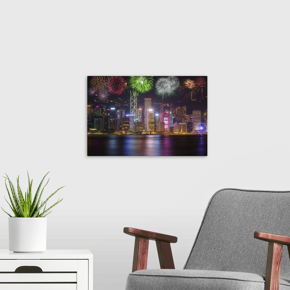A modern room featuring China, Hong Kong. Fireworks over city at night.