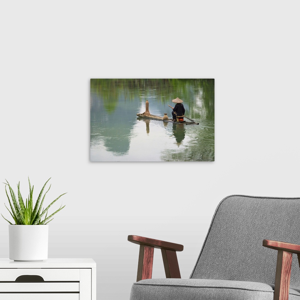 A modern room featuring Fisherman on bamboo raft on Mingshi River with karst hills, Mingshi, Guangxi Province, China
