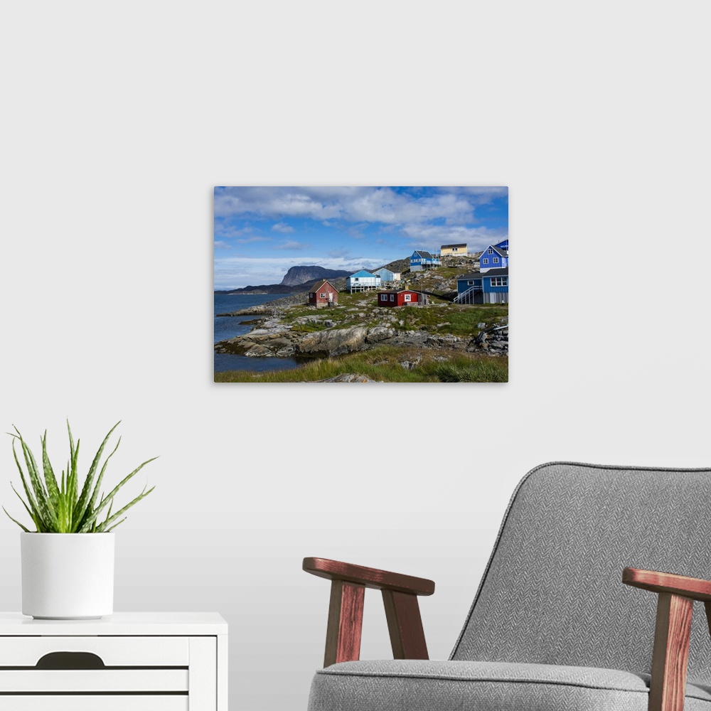 A modern room featuring Greenland. Itilleq. Colorful houses dot the hillside.