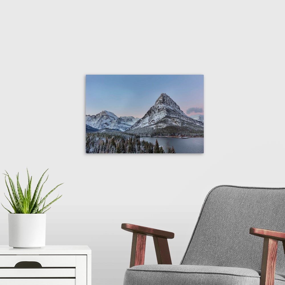 A modern room featuring Grinnell Point and Mount Gould over Swiftcurrent Lake in ealry winter in Glacier National Park, M...
