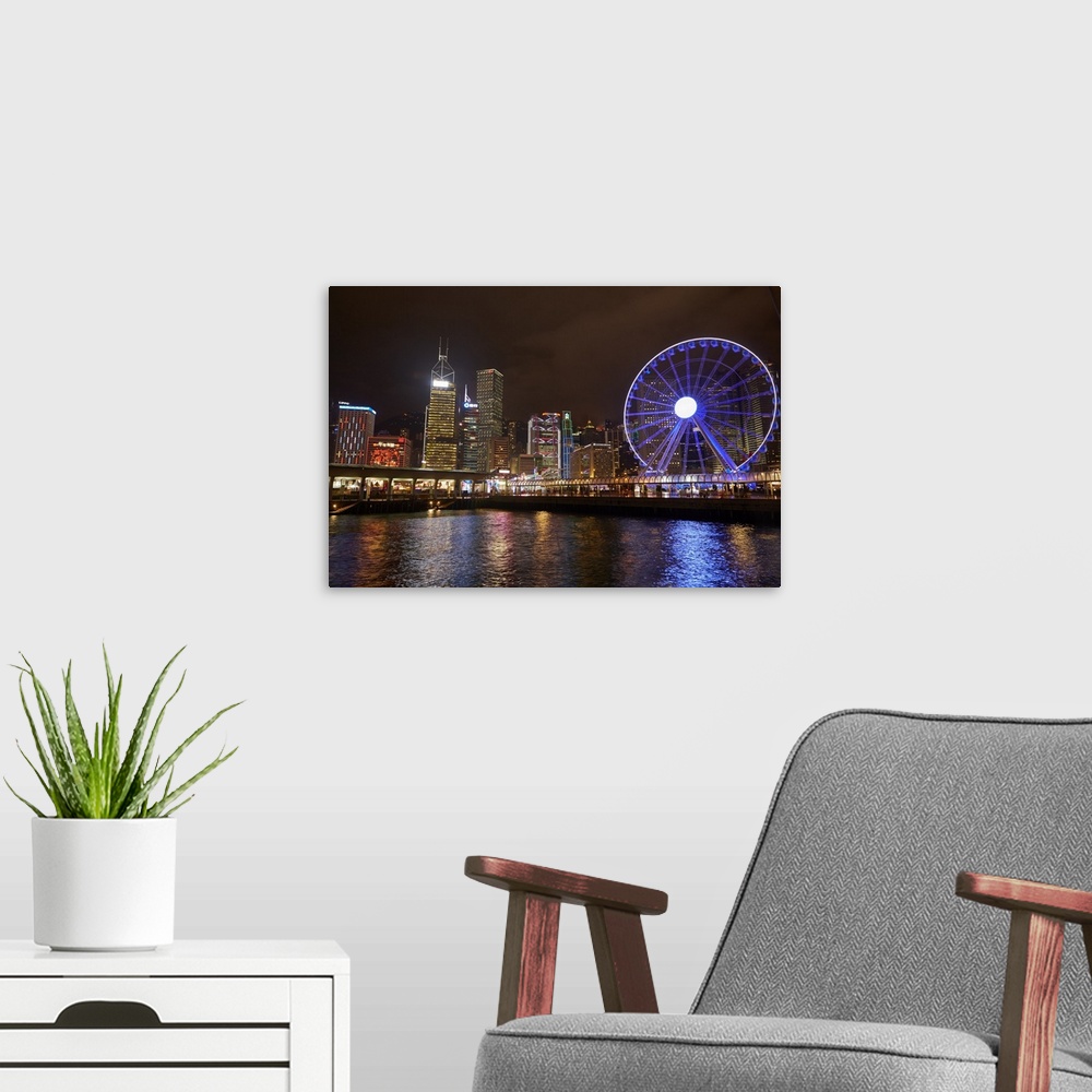 A modern room featuring Victoria Harbour, Hong Kong Observation Wheel and skyscrapers, Central, Hong Kong Island, Hong Ko...