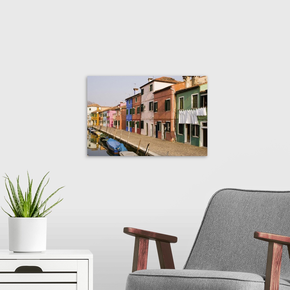 A modern room featuring Europe, Italy, Burano. Colorful houses of line a canal.