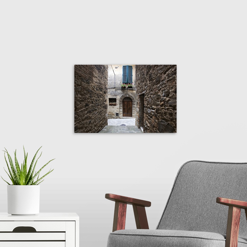 A modern room featuring Europe, Italy, Petroio. Narrow walkway frame a doorway in a Tuscany village.