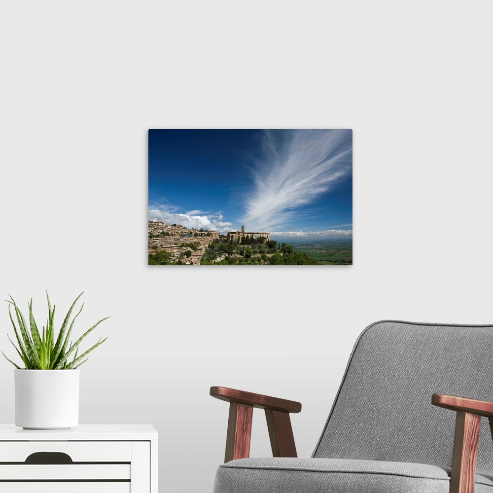 A modern room featuring Italy, Tuscany. Dramatic clouds over the hill town of Montalcino.
