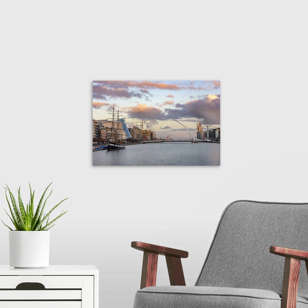 A modern room featuring Jeanie Johnston Tall Ship and Samuel Beckett Bridge over the River Liffey in downtown Dublin, Ire...
