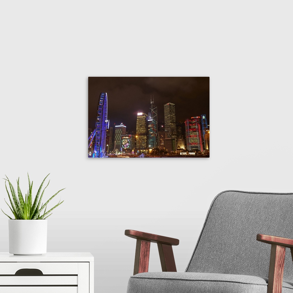 A modern room featuring Light show on skyscrapers, and Hong Kong Observation Wheel, Central, Hong Kong Island, Hong Kong,...
