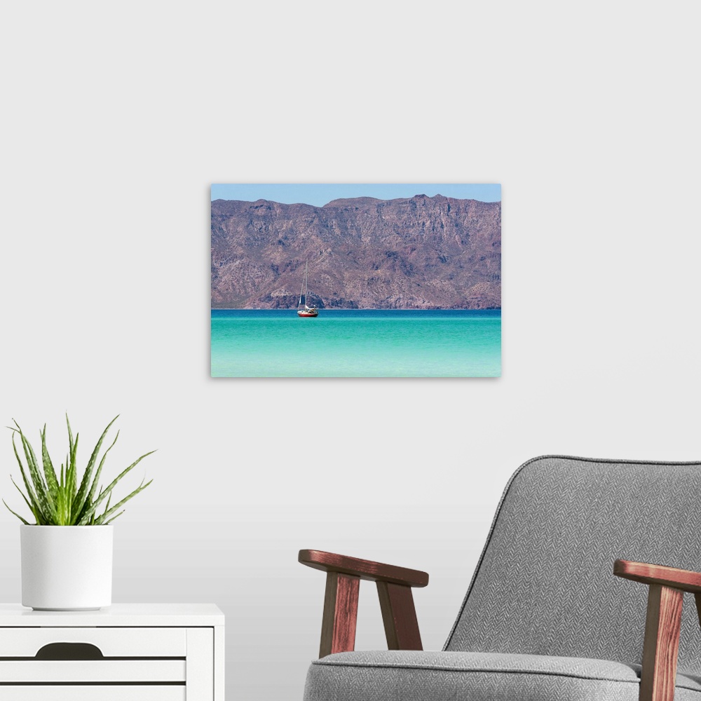 A modern room featuring Mexico, Baja California Sur, Sea of Cortez, Loreto Bay. Lone sailboat on flat calm water with Sie...