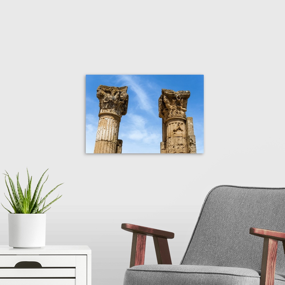 A modern room featuring Roman Corinthian capital, Utica Punic and Roman archaeological site, Tunisia, North Africa.