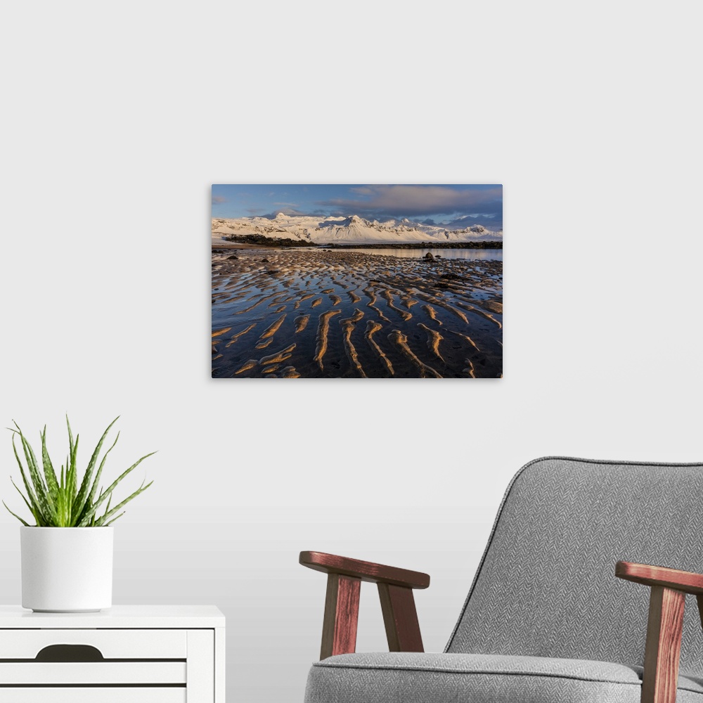 A modern room featuring Snow capped mountain above the North Atlanic shoreline on the Snaefellsnes peninsula in western I...