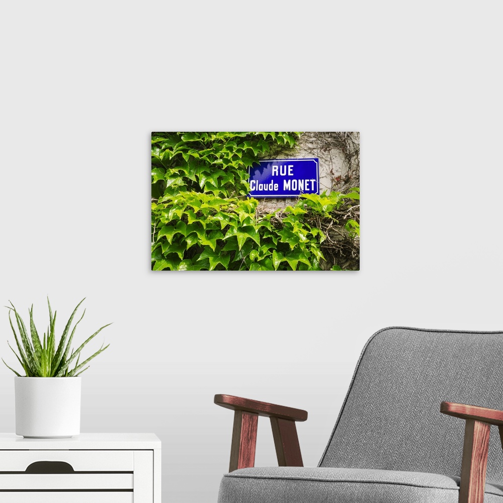 A modern room featuring Street sign and ivy covered wall, Giverny, Normandy, France.