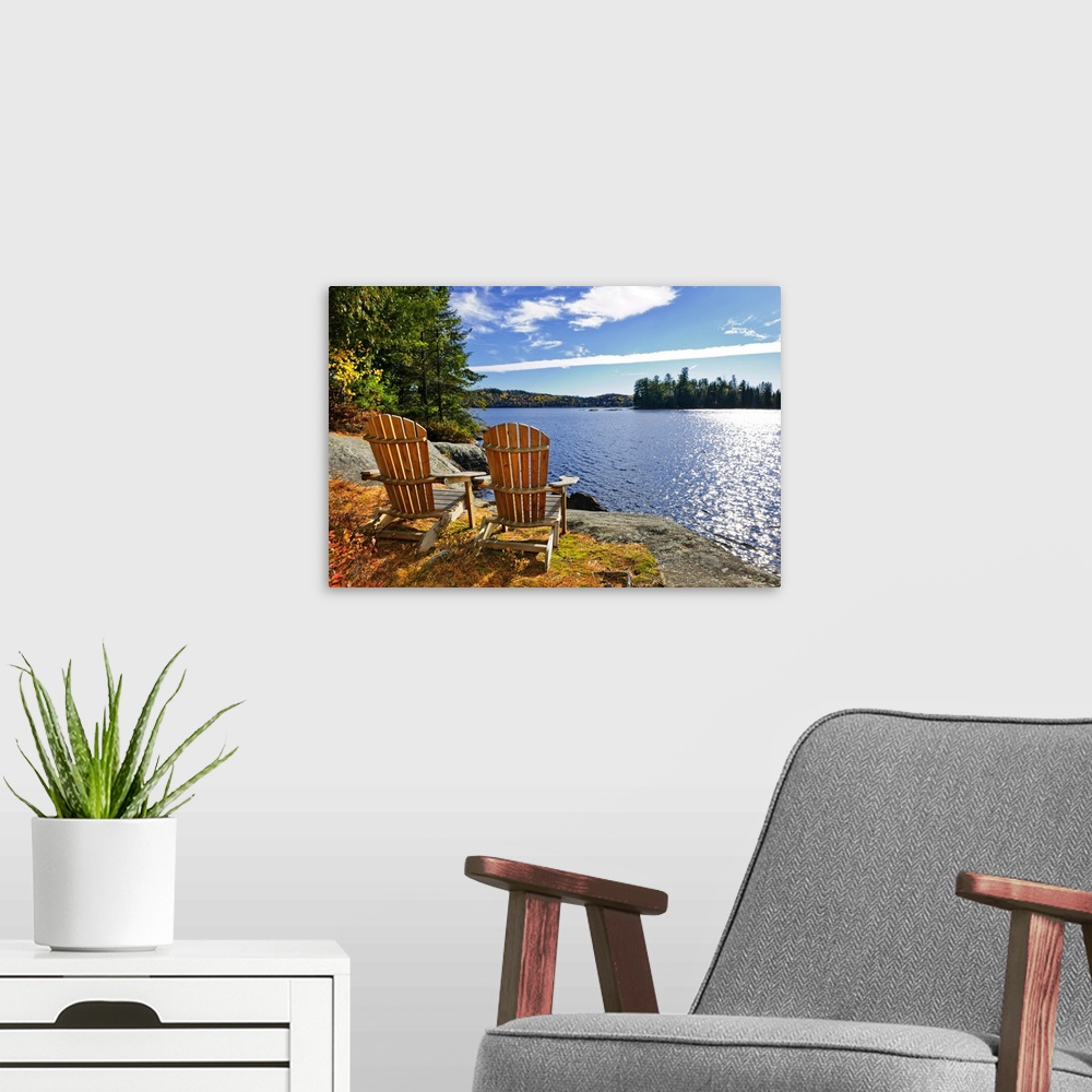 A modern room featuring Adirondack chairs at shore of Lake of Two Rivers, Ontario, Canada.