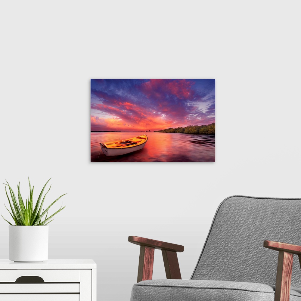A modern room featuring A rowboat watches an amazing sunset.
