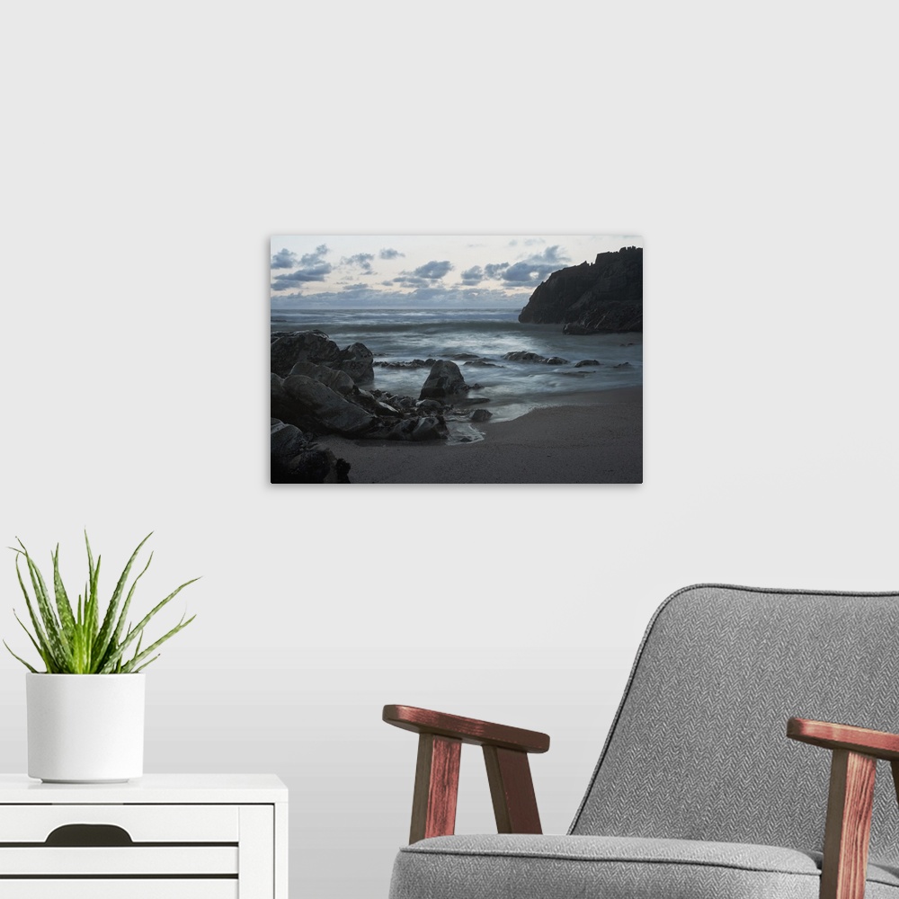 A modern room featuring Northern portuguese rocky coast at dusk. Long exposure.