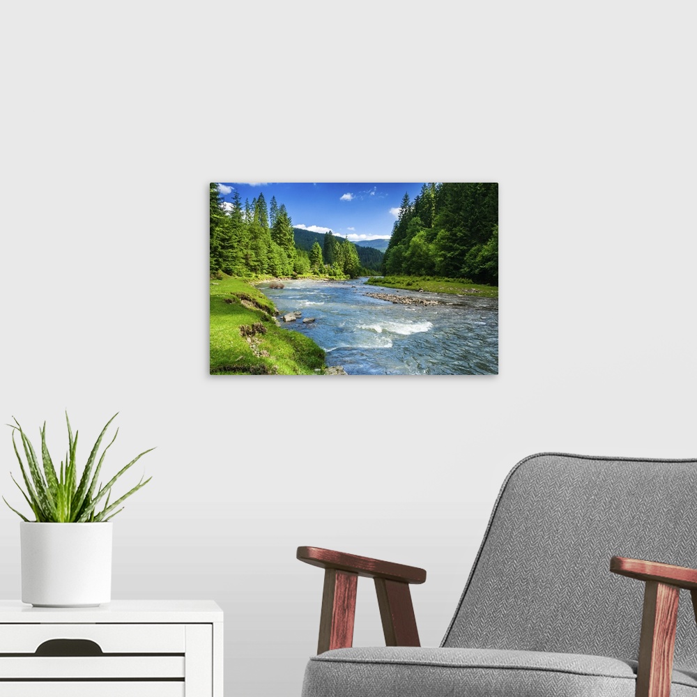 A modern room featuring Landscape with mountains trees and a river in front.