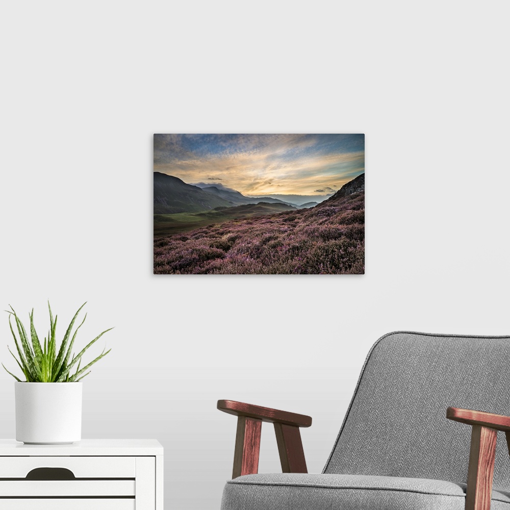 A modern room featuring Stunning sunrise mountain landscape with vibrant colors and beautiful cloud formations.
