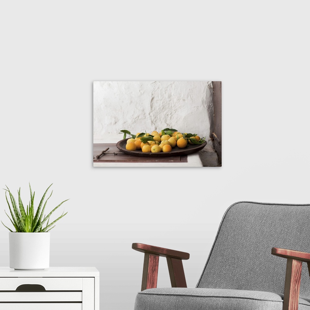 A modern room featuring Spain, Balearic Islands, Mallorca, Pollenca, Freshly picked oranges in dish