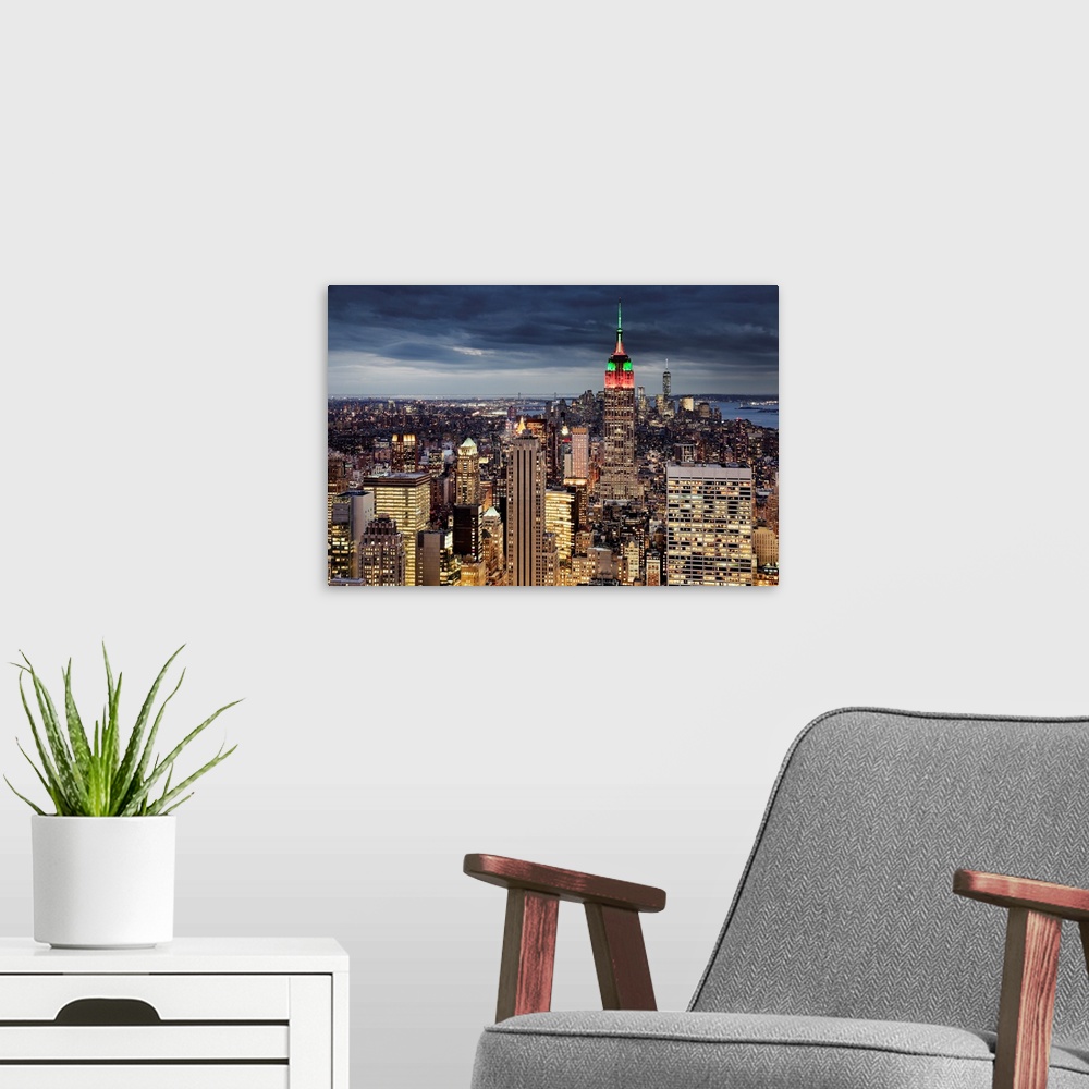A modern room featuring USA, New York City, Midtown skyline and Empire State building from the Rockefeller Center Top of ...