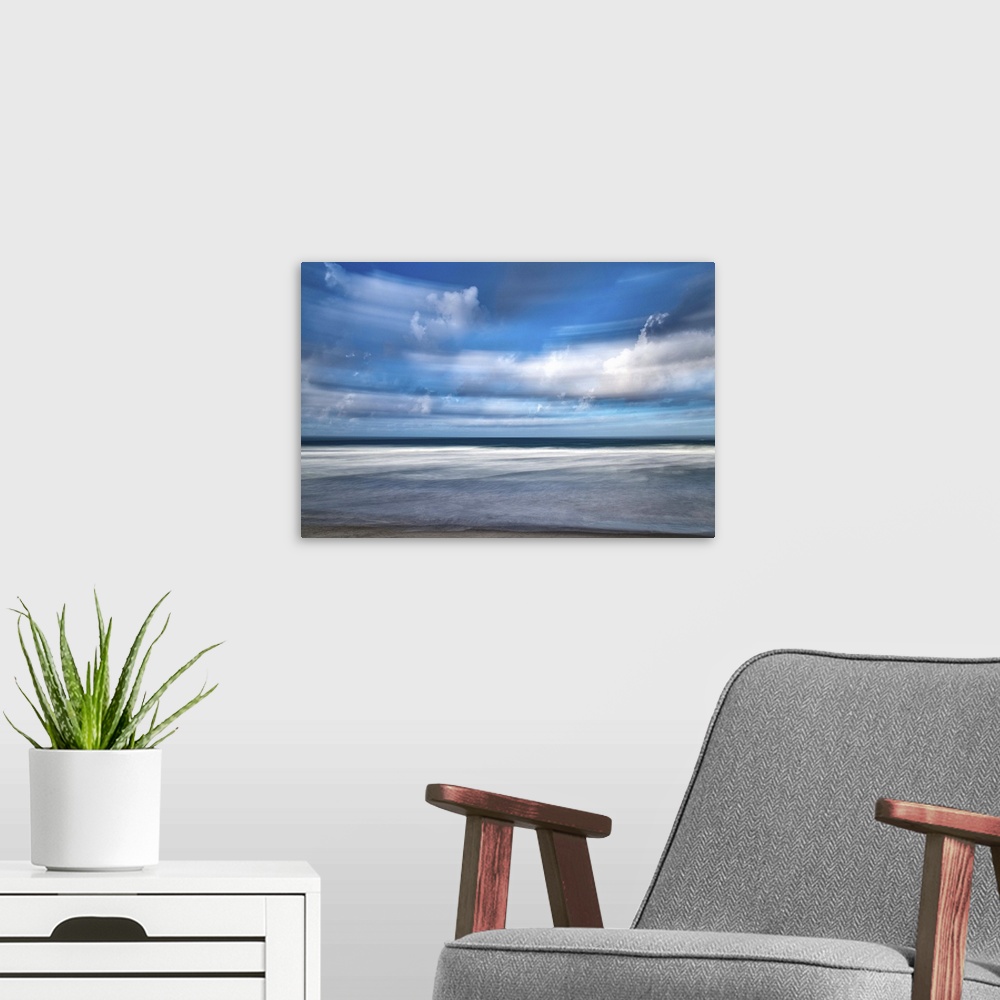 A modern room featuring Photograph of storm clouds at beach blurred with long exposure.