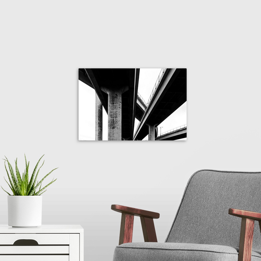 A modern room featuring Black and white abstract photograph of freeway bridges.