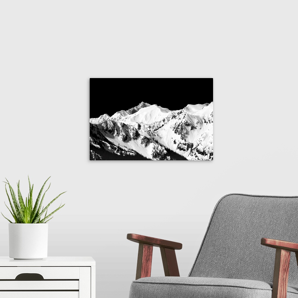 A modern room featuring Black and white photograph of snowy mountain peaks.
