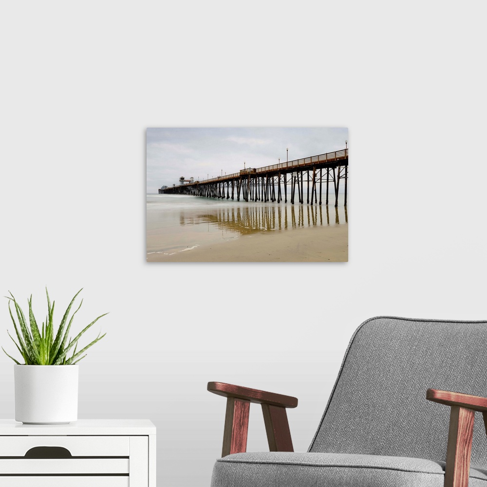 A modern room featuring Photograph of Oceanside Pier at low tide.
