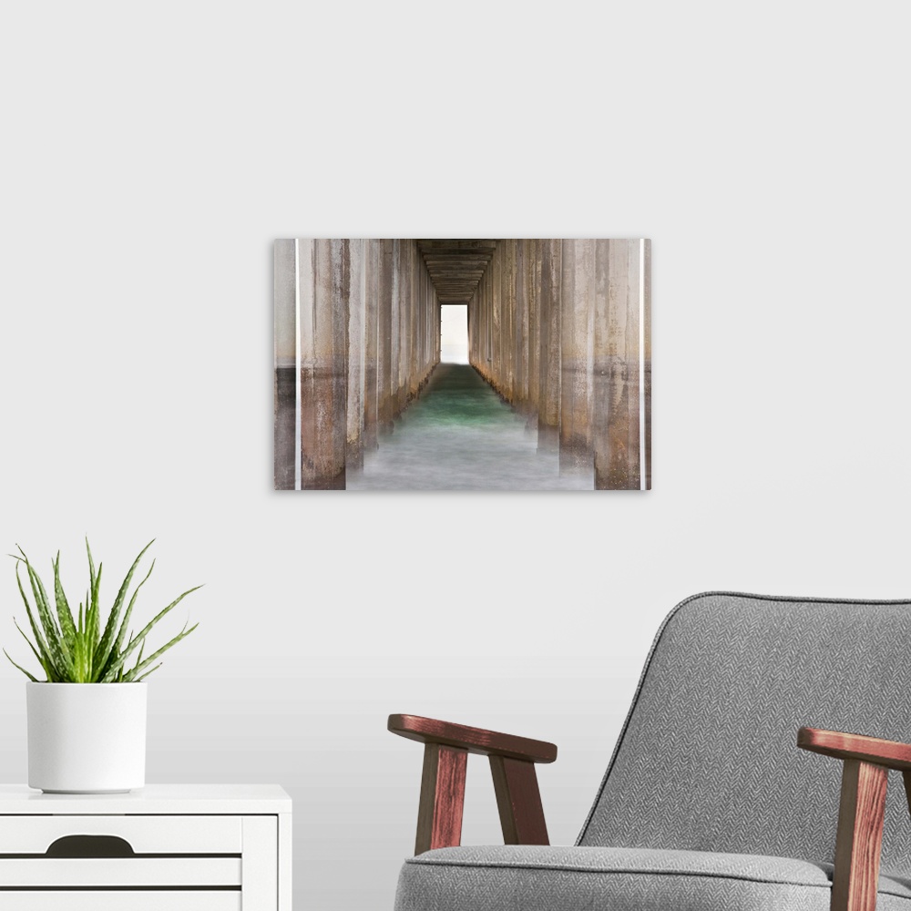 A modern room featuring Photograph of the bottom of a pier creating leading lines through the ocean to the end of the pier.