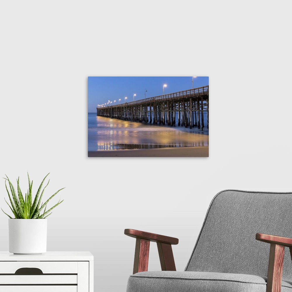 A modern room featuring Photograph of Ventura pier lit up at night.
