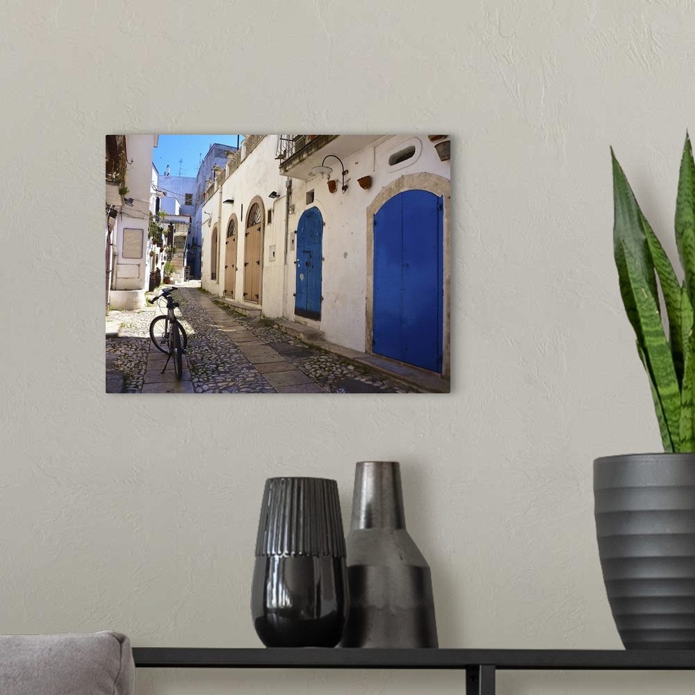 A modern room featuring A bicycle in the middle of the street in Puglia, Italy