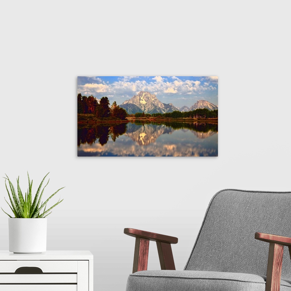 A modern room featuring Mount Moran reflected in the still water of the Snake River in Grand Teton National Park during t...