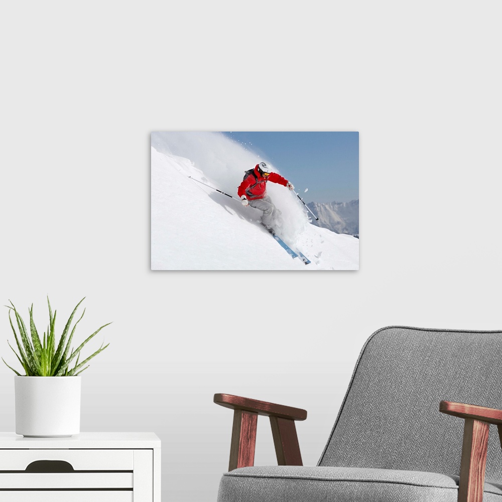 A modern room featuring Austria, Saalbach, male skier turning in snow on slope