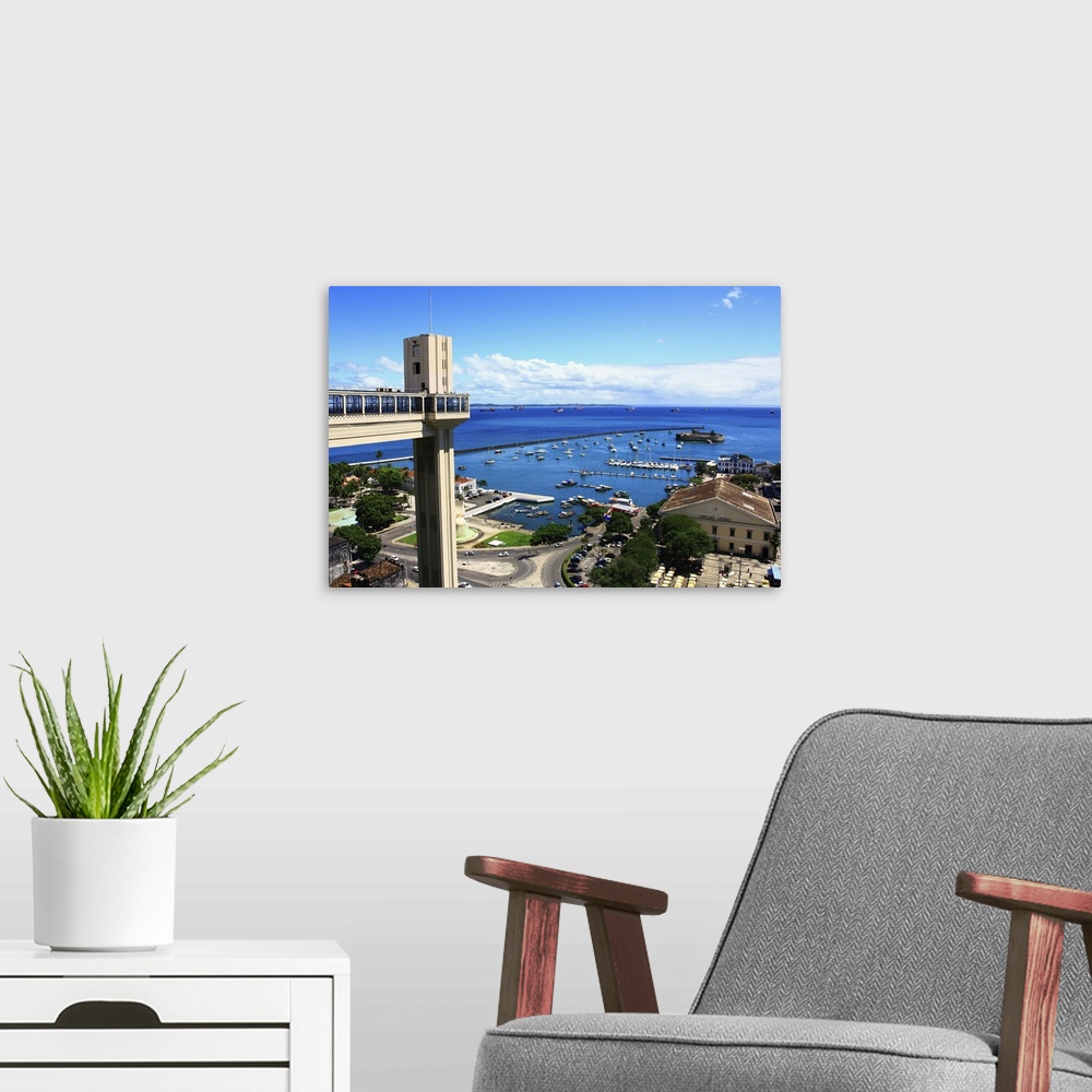 A modern room featuring View of the Bay of All Saints, the Mercado Modelo, blue sky, endless ocean and Elevador Lacerda. ...