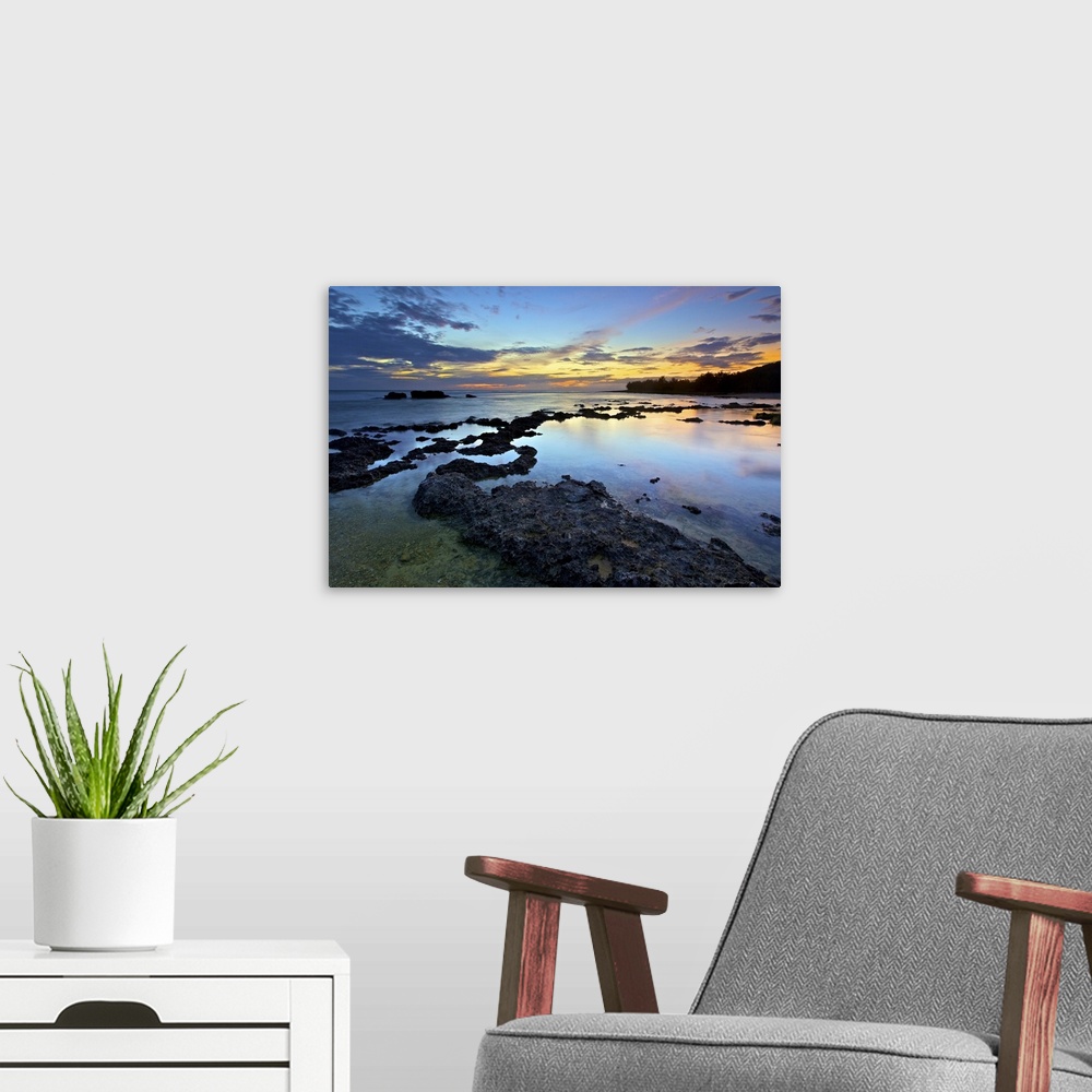 A modern room featuring Blue dusk at Wanliton, Pingtung, Taiwan, while blue sky and orange clouds above horizon are refle...
