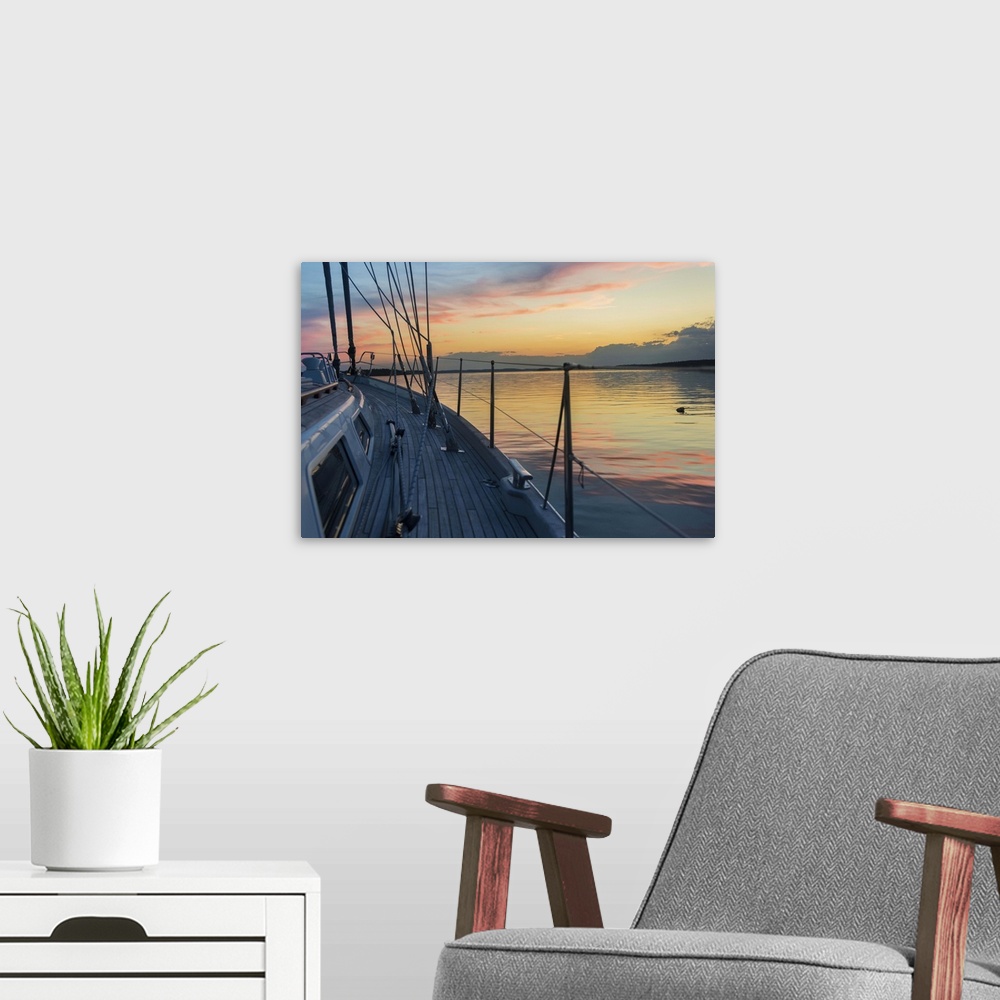 A modern room featuring Bow of 62 ft sailboat at sunset