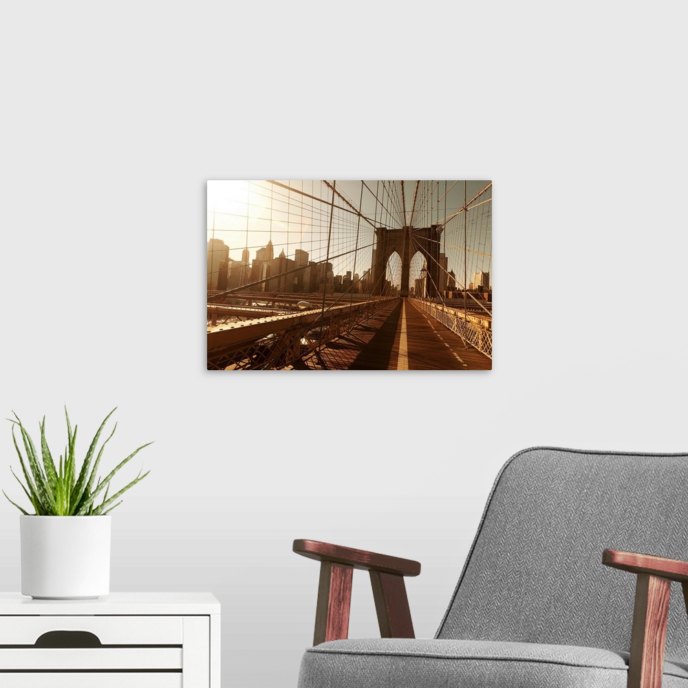 A modern room featuring Landscape, oversized photograph of the Brooklyn Bridge, taken through a multitude of cables, with...
