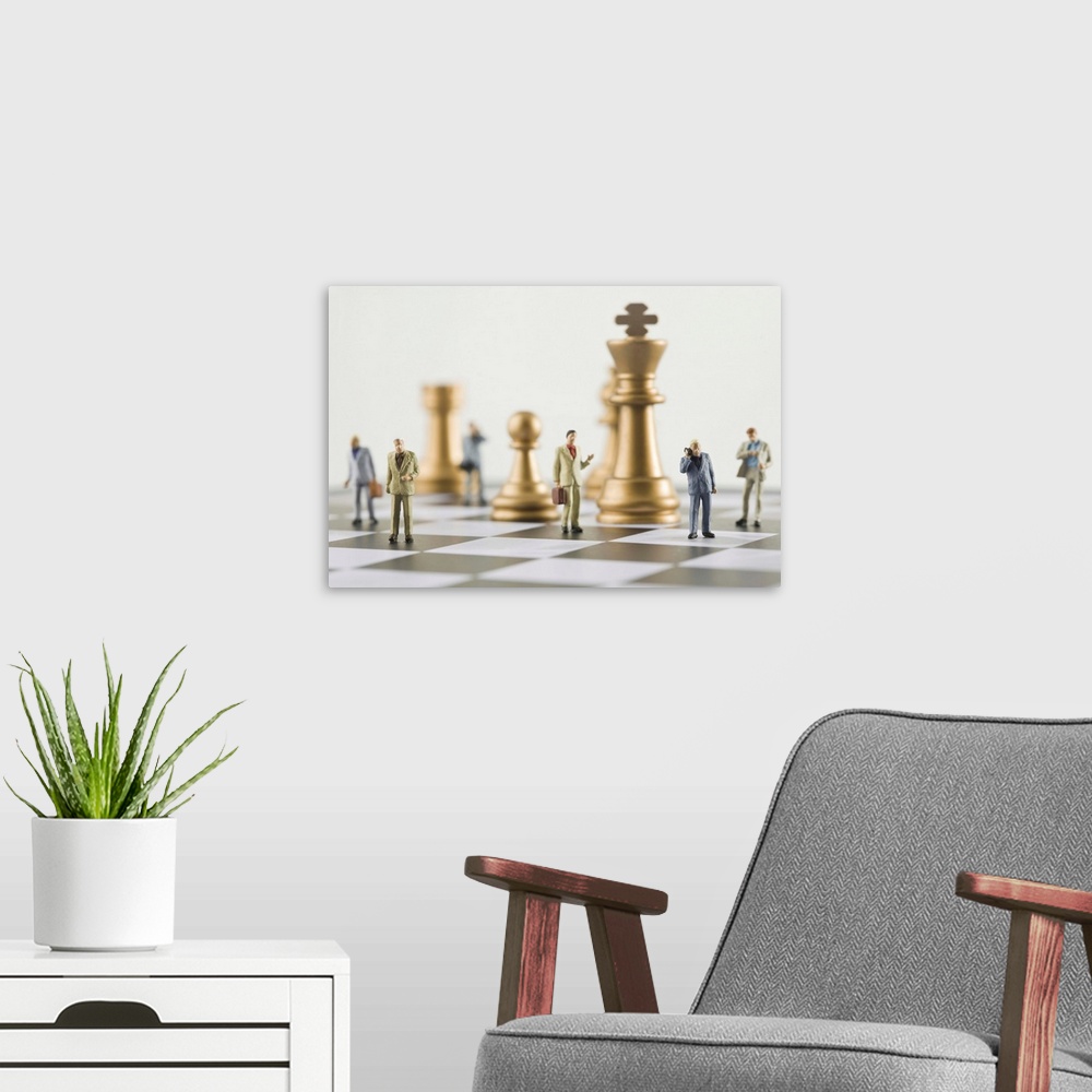 A modern room featuring Businessmen figurines standing a top chess board (focus on foreground)