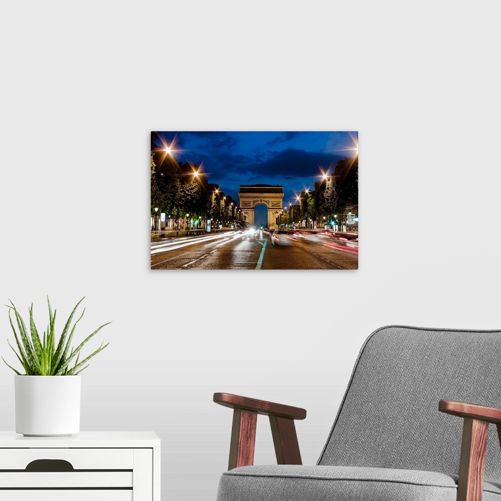 A modern room featuring Champs Elysees and Arc de Triomphe at dusk.