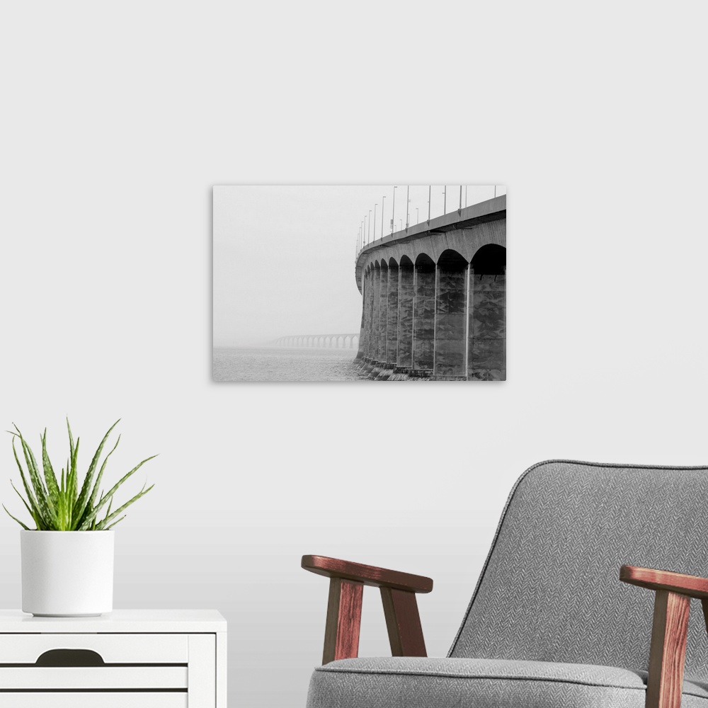 A modern room featuring Confederation bridge, Prince Edward Island and New Brunswick on a cloudy foggy day.